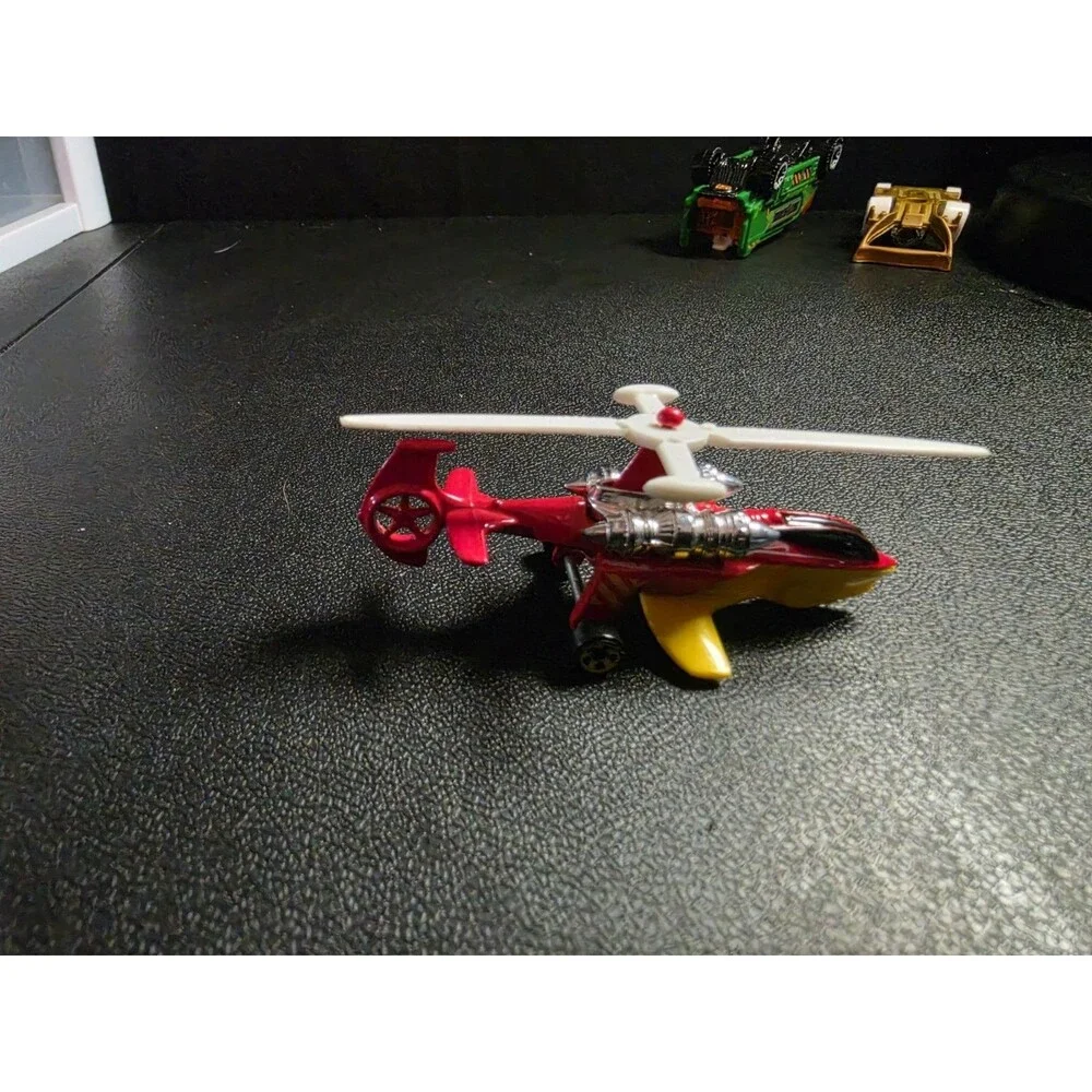 Lot of 4 loose Hot Wheels vehicles in pre-owned condition.